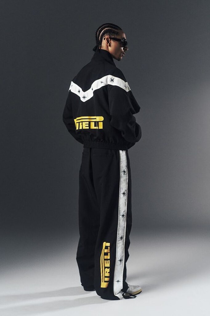 Gen-Z Clothing streetwear model wearing oversized black jacket and wide-leg track pants with modern urban fashion style
